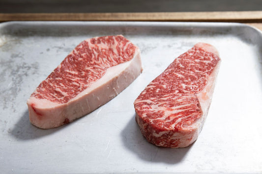 Wagyu sirloin steaks MB4+ on a silver tray